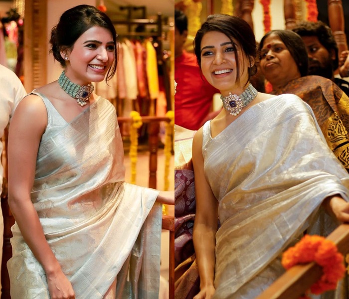 Image of A woman in a red saree at a temple wearing gold choker necklace  with Emerald, pearls along with Earrings-AV846376-Picxy