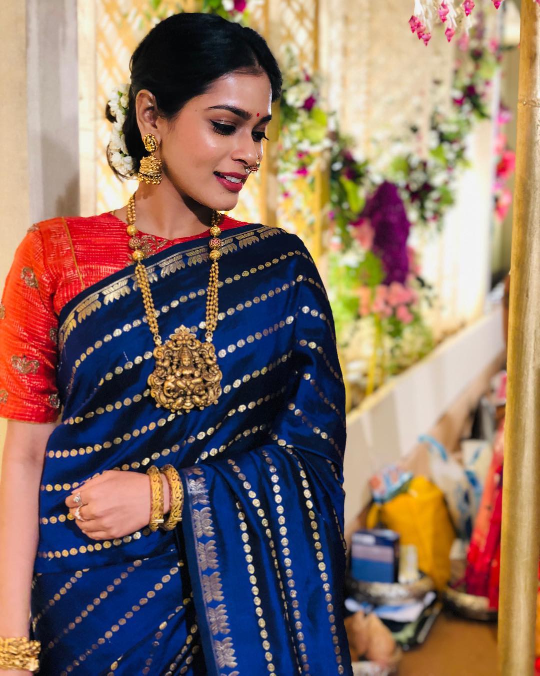 Photo of Bride in a gold and mint green saree with diamond jewellery.