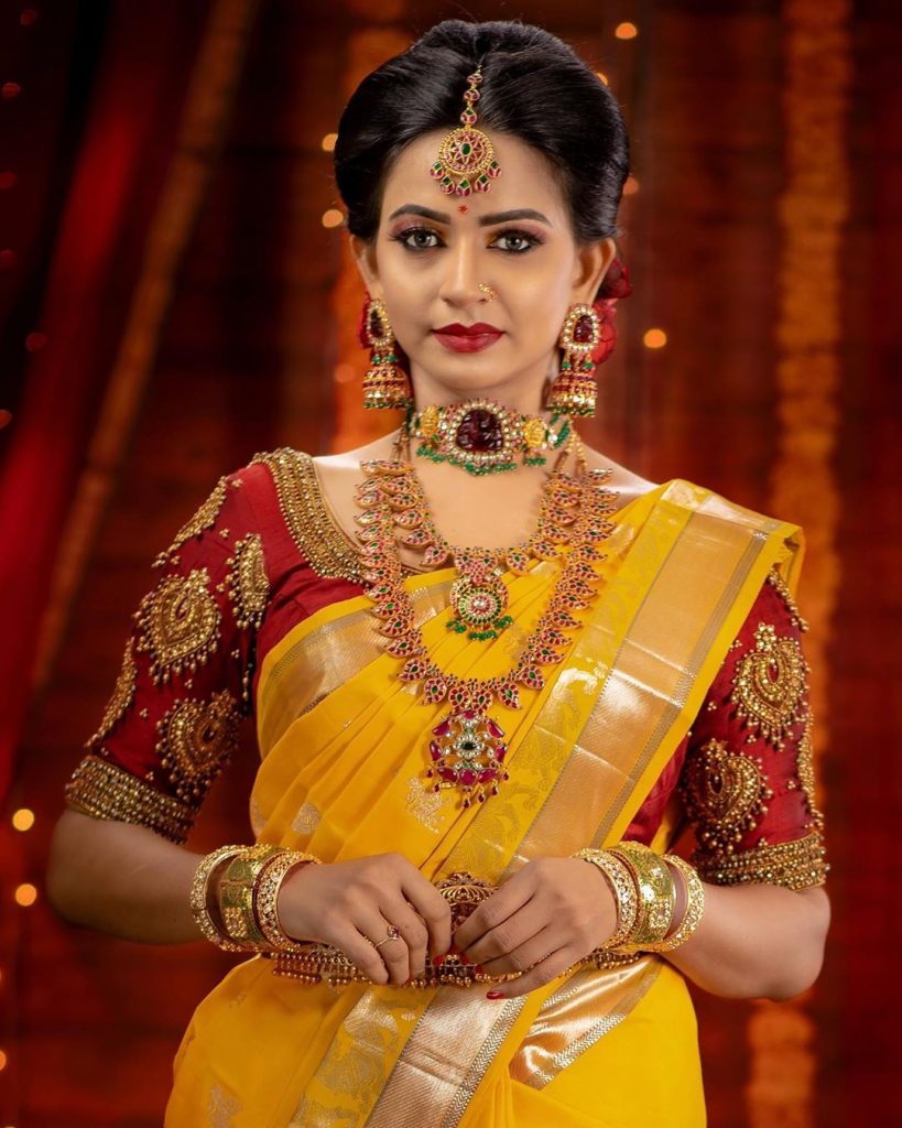 Photo of South Indian Bride wearing a pink silk saree with temple jewellery.