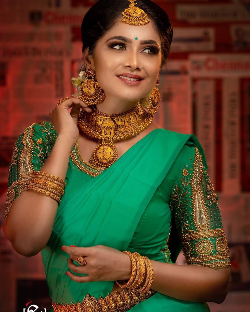 Photo of South Indian Bride wearing a white and green saree with temple  jewellery.